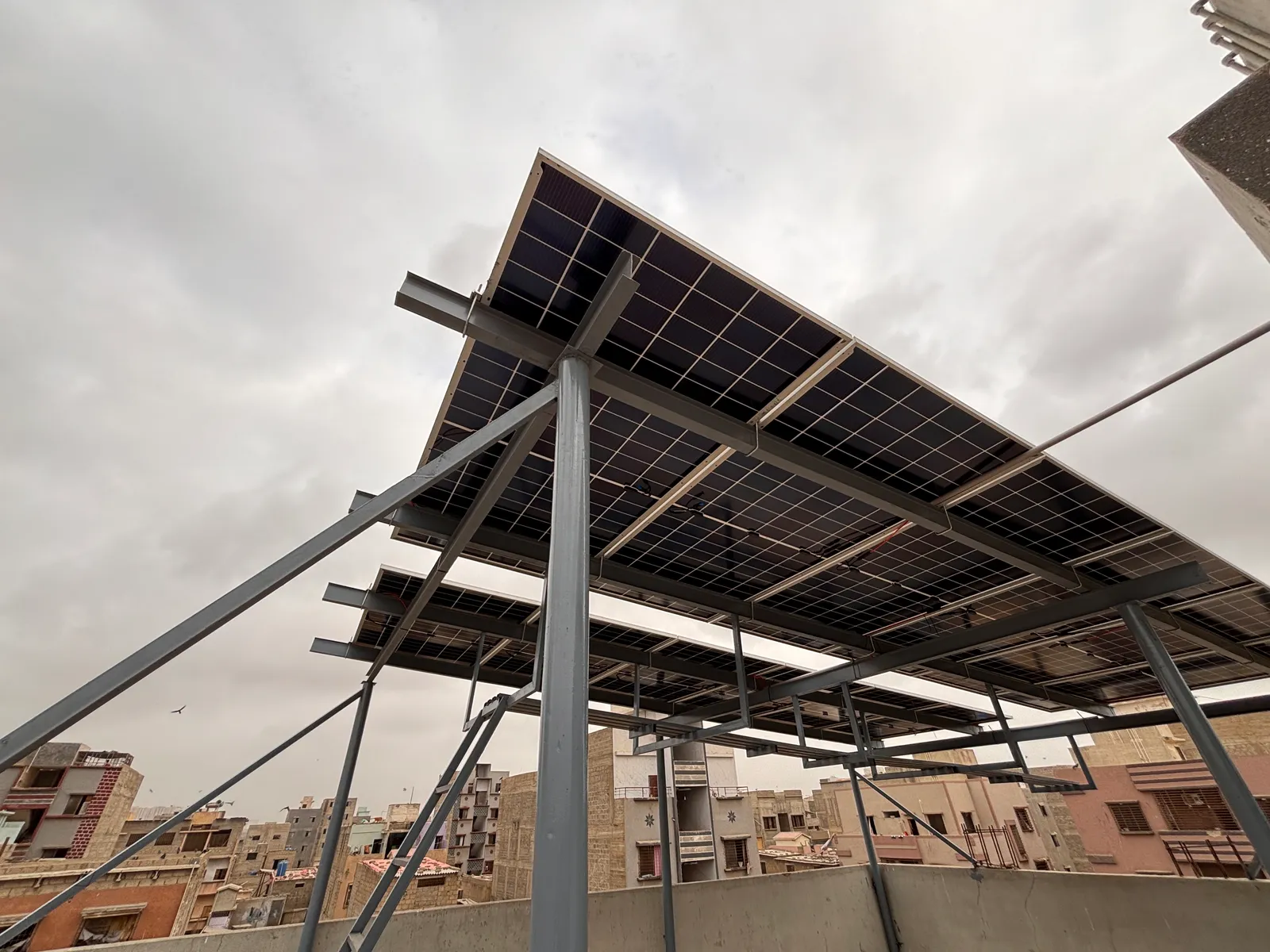 Large elevated solar array raised on a steel frame by APC Solar in Karachi