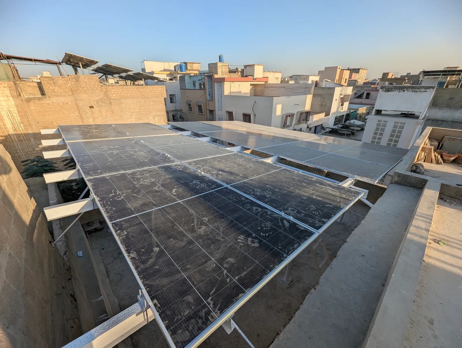 Flush rooftop solar array spanning the roof, installed by APC Solar in Karachi
