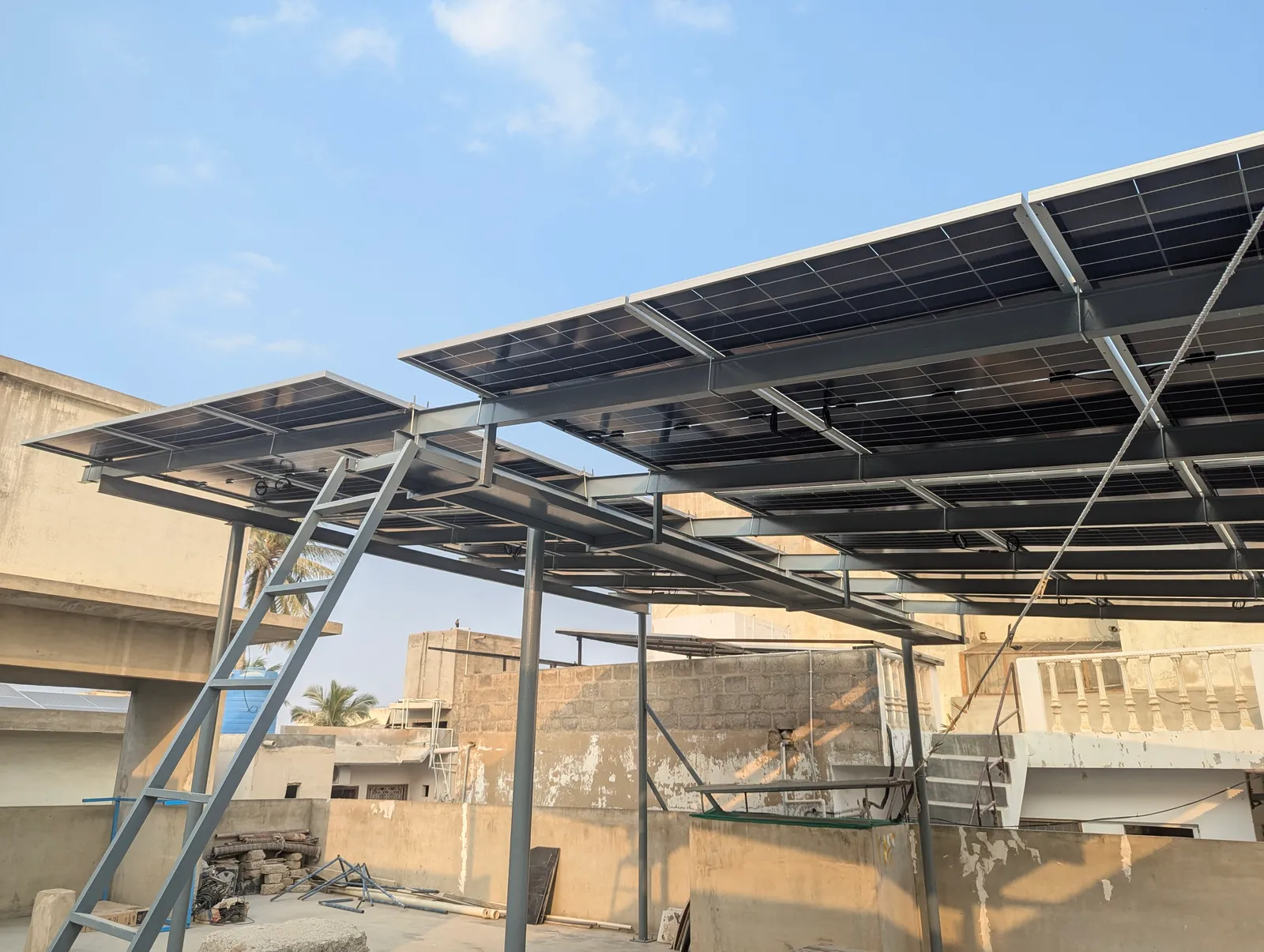 Elevated steel solar structure carrying an array above a Karachi rooftop, by APC Solar