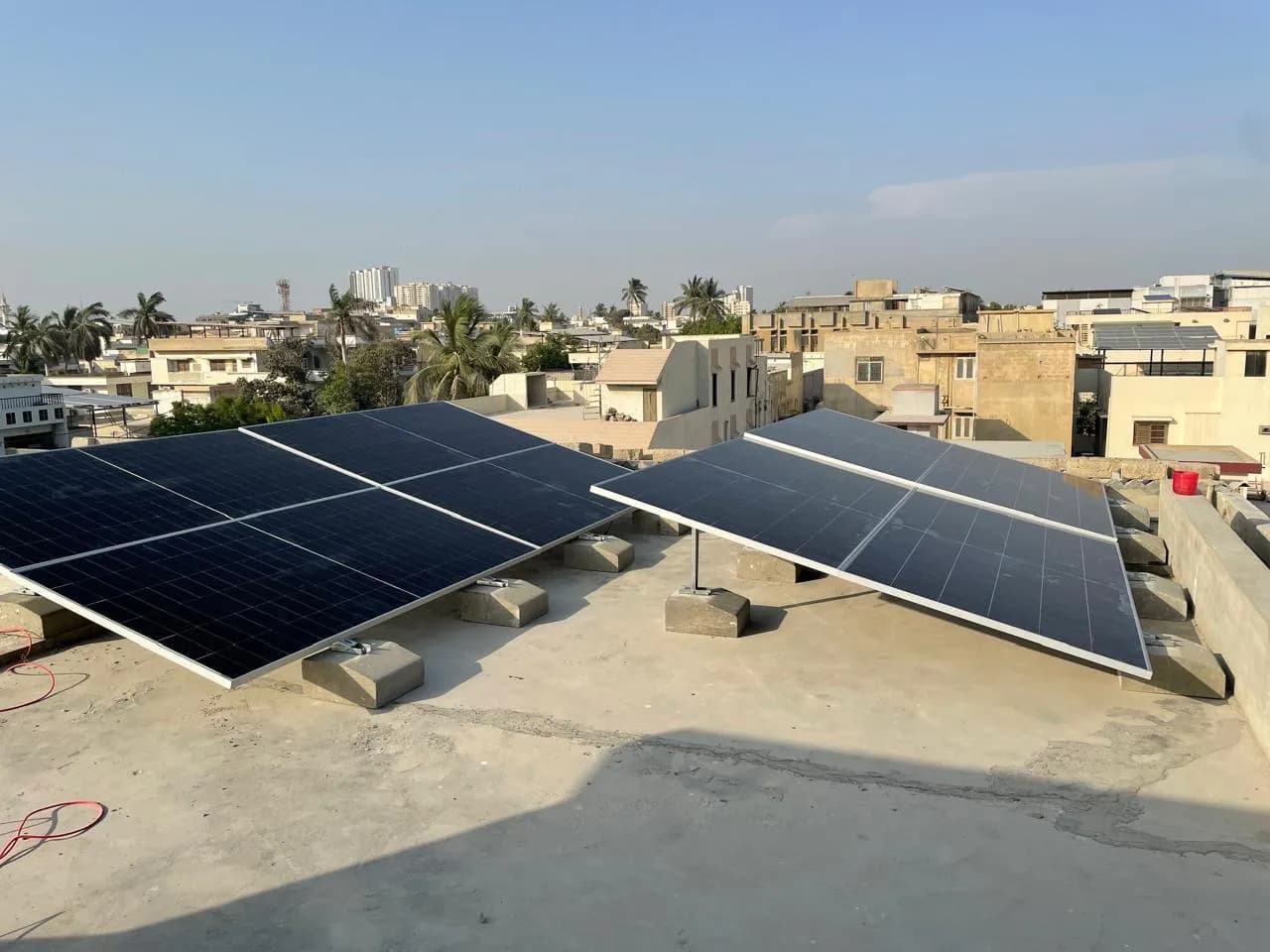 Tilted, ballasted rooftop solar array installed by APC Solar in Karachi