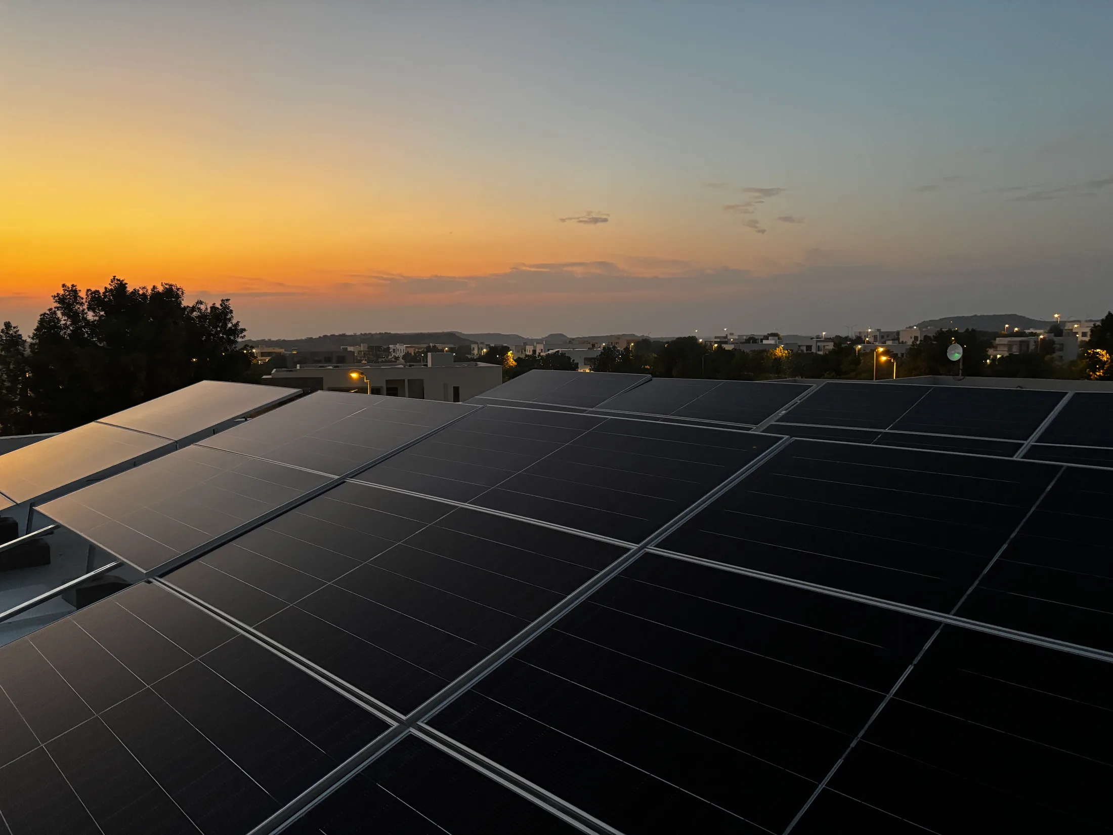 Rooftop solar array installed by APC Solar catching the evening sun over Karachi